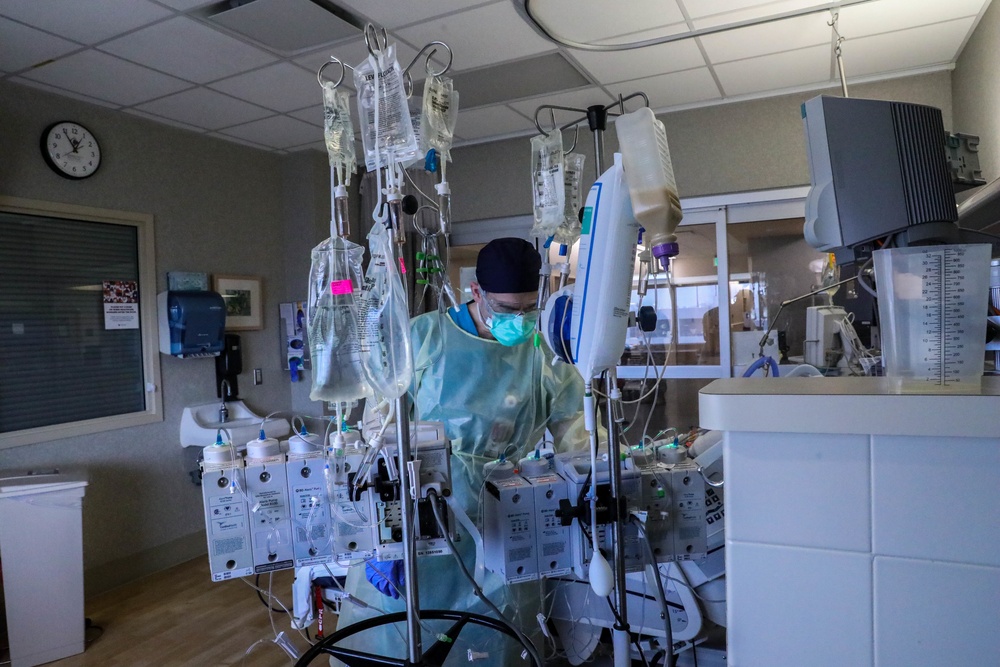 U.S. service members, local medical professional work together