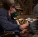 USS America (LHA 6) Sailor holds pressure gauge during drill.