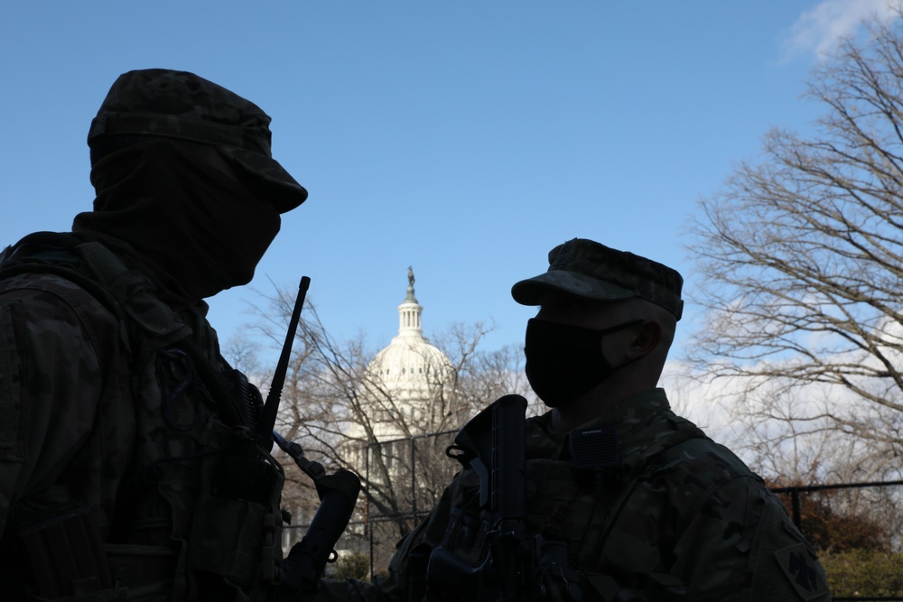 National Guard Soldiers talk near the U.S. Capitol.