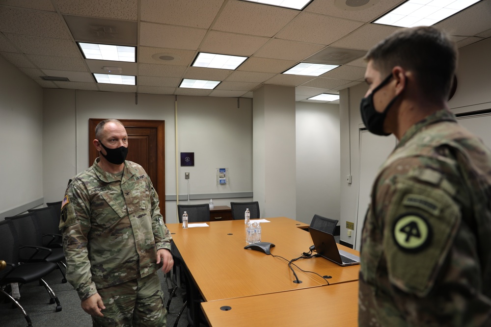 Col. Hughes talks with the Commander of Company C, 114th Infantry Regiment