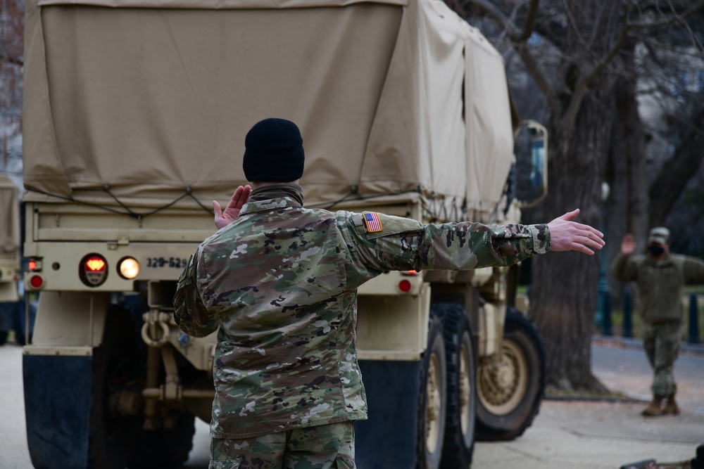 National Guard Soldiers back a truck into position near the U.S. Capitol in Washington, D.C., prior to the 59th Presidential Inauguration, Jan. 20, 2021