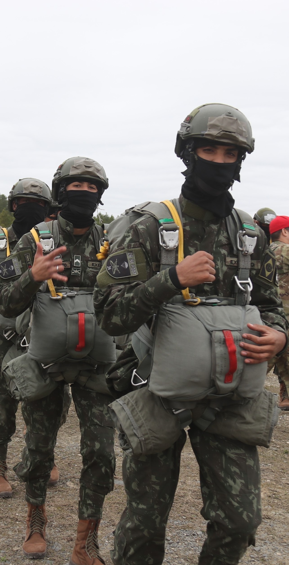 Three Brazilian Paratroopers showing their motivation in line for jump at JRTC 21-04.