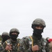 Three Brazilian Paratroopers showing their motivation in line for jump at JRTC 21-04.