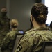 Army and Navy personnel receive command briefings during in-processing for COVID-19 response