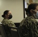 Army and Navy personnel receive command briefings during in-processing for COVID-19 response