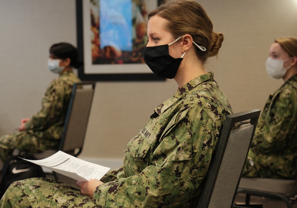 Army and Navy personnel receive command briefings during in-processing for COVID-19 response