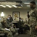 Army and Navy personnel receive command briefings during in-processing for COVID-19 response