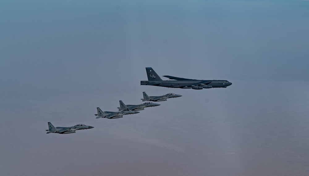 B-52 Stratofortresses fly in formation with U.S. Air Force F-15E Strike Eagles, Saudi Royal Air Force fighter jets, and U.S. Navy F/A-18 Hornets