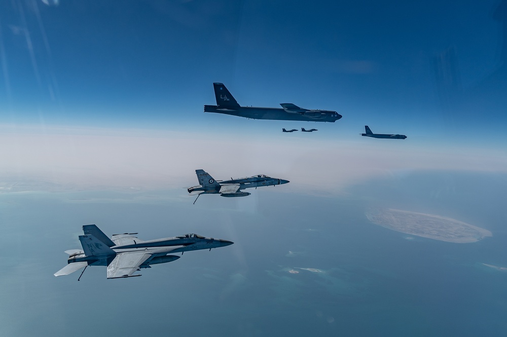 B-52 Stratofortresses fly in formation with U.S. Air Force F-15E Strike Eagles, Saudi Royal Air Force fighter jets, and U.S. Navy F/A-18 Hornets