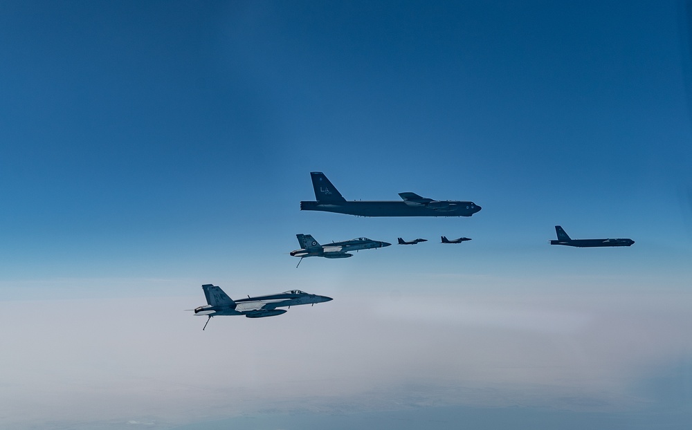 B-52 Stratofortresses fly in formation with U.S. Air Force F-15E Strike Eagles, Saudi Royal Air Force fighter jets, and U.S. Navy F/A-18 Hornets