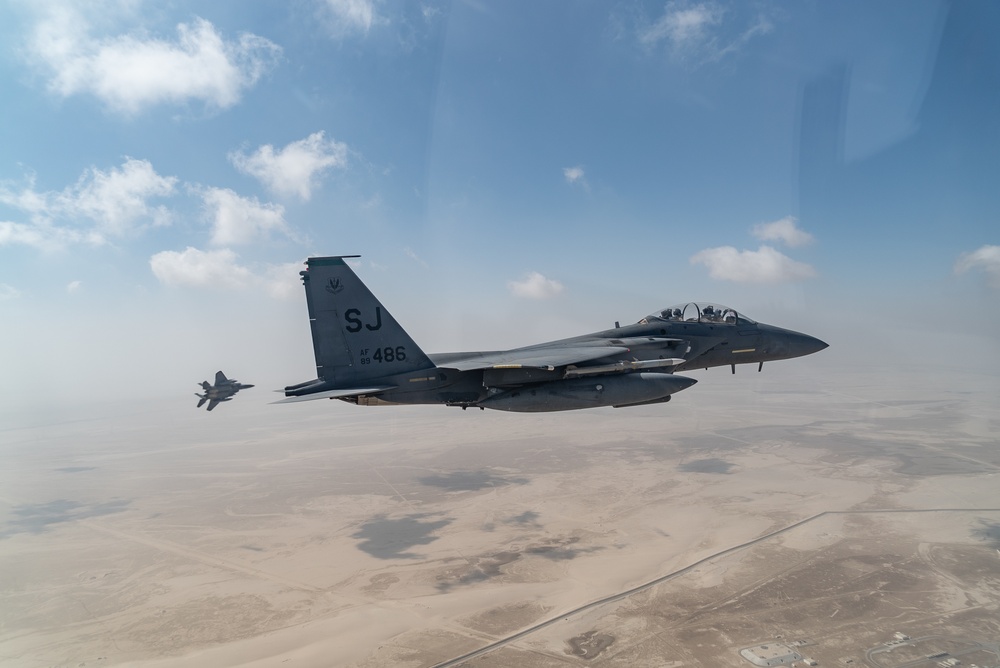 B-52 Stratofortresses fly in formation with U.S. Air Force F-15E Strike Eagles, Saudi Royal Air Force fighter jets, and U.S. Navy F/A 18 Hornets