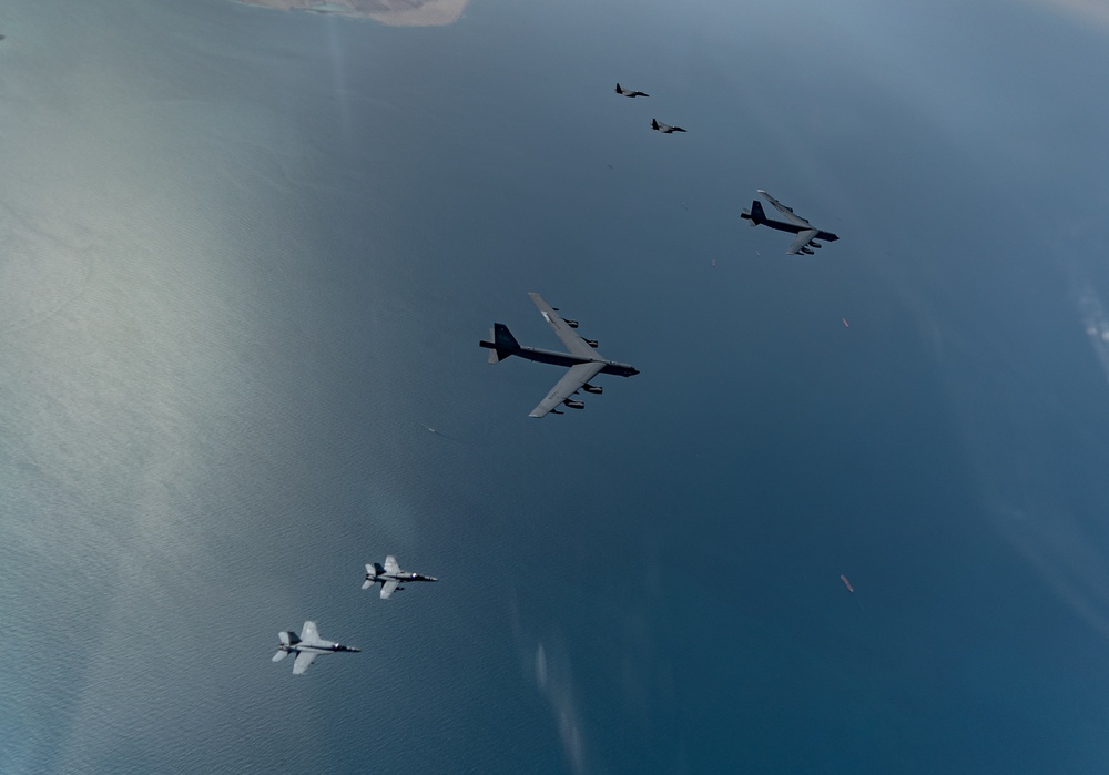 B-52 Stratofortresses fly in formation with U.S. Air Force F-15E Strike Eagles, Saudi Royal Air Force fighter jets, and U.S. Navy F/A-18 Hornets