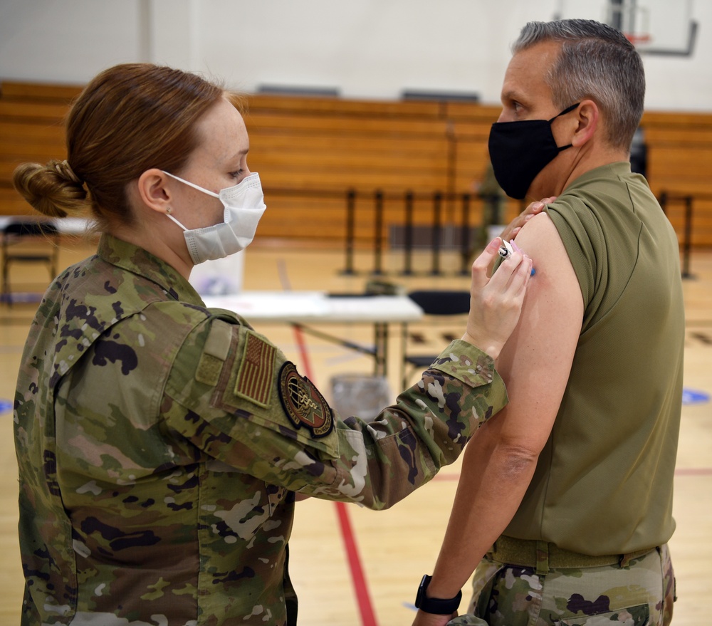 Airmen from the 621st Contingency Response Wing receive a COVID-19 vaccination