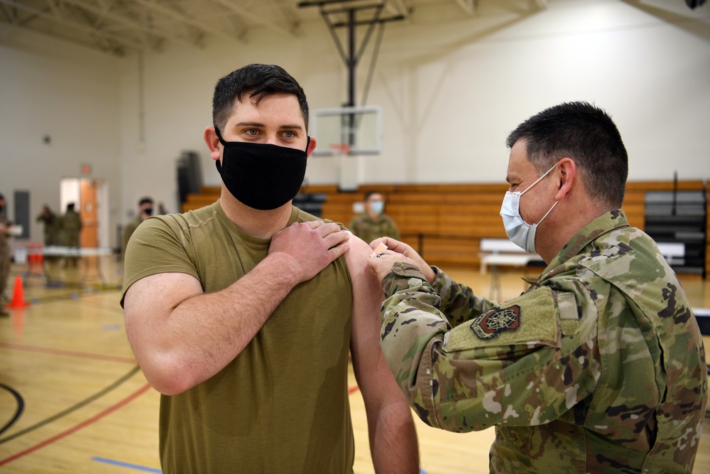 Airmen from the 621st Contingency Response Wing receive a COVID-19 vaccination