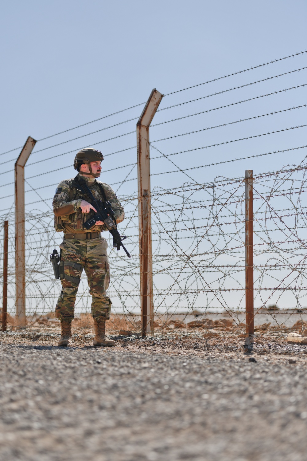 Members of the 332 Expeditionary Security Forces Squadron Sweep Perimeter Road