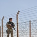 Members of the 332 Expeditionary Security Forces Squadron Sweep Perimeter Road