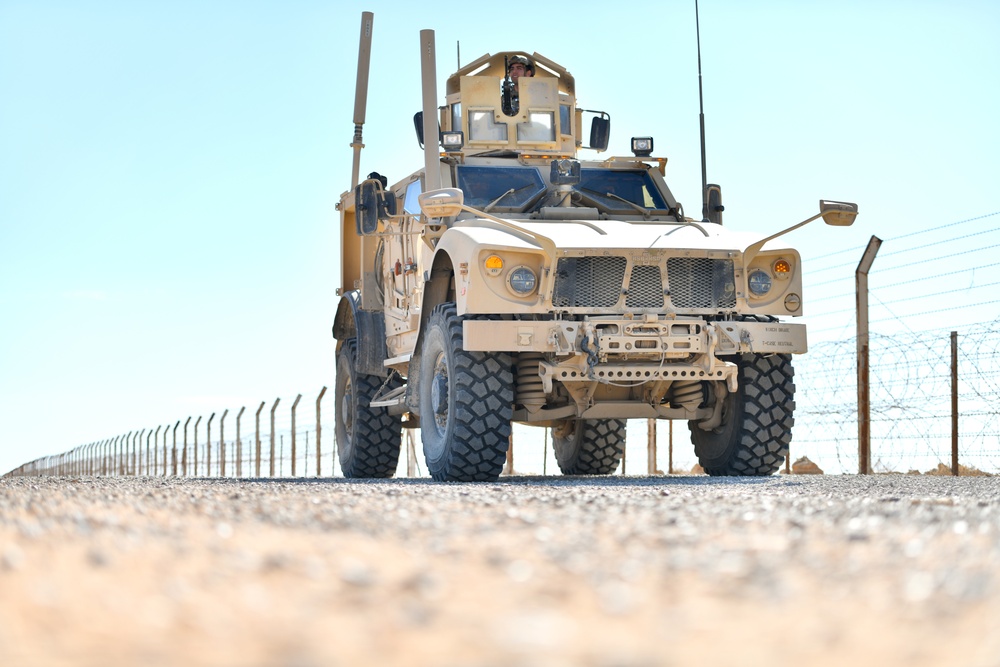 Members of the 332 Expeditionary Security Forces Squadron Sweep Perimeter Road