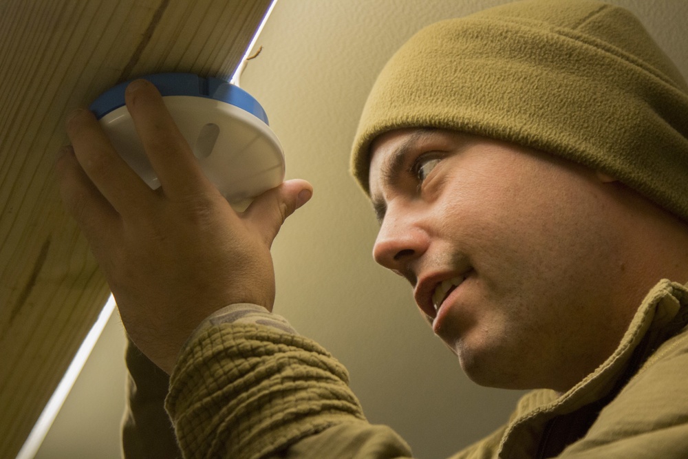 A Marine with Golf Co., 2MRSB, installs electrical wiring during TRXII
