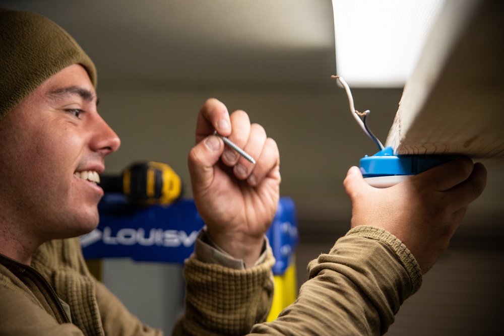 A Marine with Golf Co., 2MRSB, installs electrical wiring during TRXII
