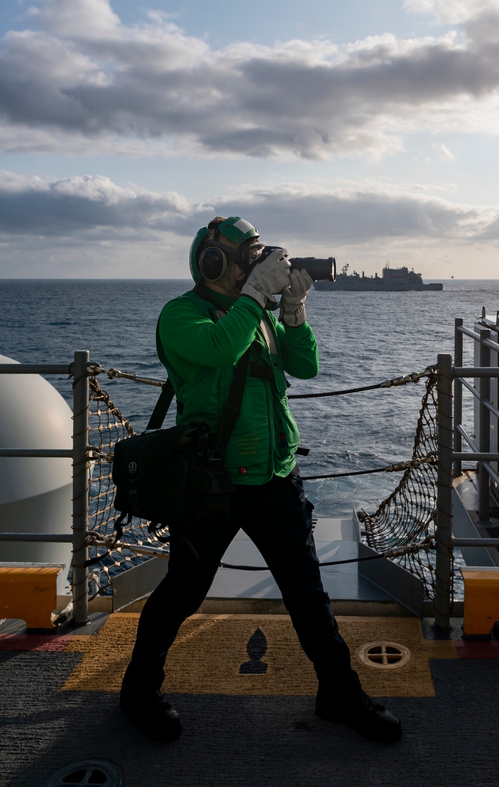 USS America (LHA 6) Sailor takes photos during RAS.