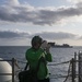 USS America (LHA 6) Sailor takes photos during RAS.