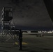 Preparing an aircraft stand for a post-flight inspection after a Red Flag 21-1 nighttime training mission