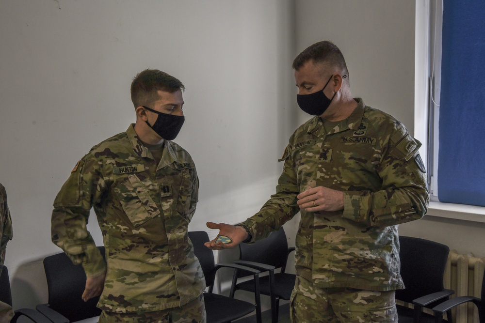 U.S. Army Maj. General Christopher Mohann presents his coin to Kentucky Army National Guard Captain Ryan Hunton.