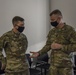 U.S. Army Maj. General Christopher Mohann presents his coin to Kentucky Army National Guard Captain Ryan Hunton.