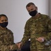 U.S. Army Maj. General Christopher Mohann presents his coin to Alaska Army National Guard Staff Sgt. Jennessymae Buendia