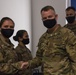 U.S. Army Maj. General Christopher Mohann presents his coin to Alaska Army National Guard Staff Sgt. Corine Barrera.