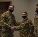 U.S. Army Maj. General Christopher Mohann presents his coin to Alaska Army National Guard Specialist Delaney Pletsch