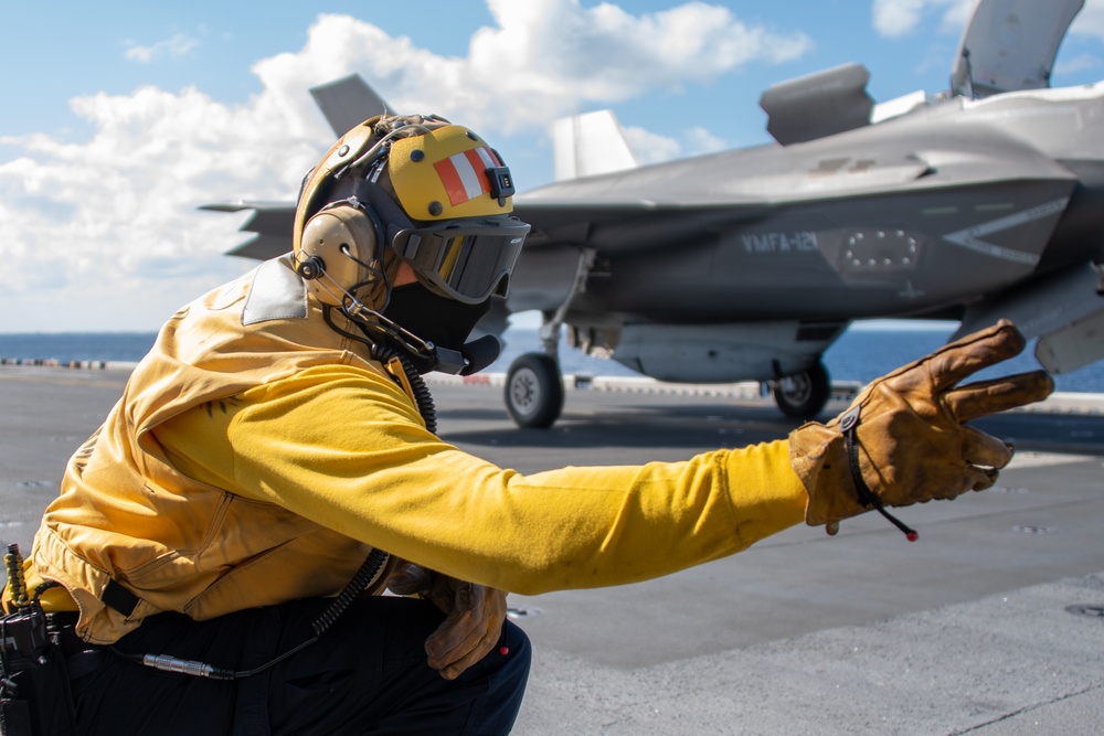 Sailors assigned to the forward-deployed amphibious assault ship USS America (LHA 6) conduct flight operations.