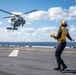 Sailors assigned to the forward-deployed amphibious assault ship USS America (LHA 6) conduct flight operations.