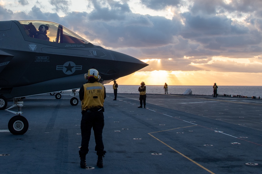 Sailors assigned to the forward-deployed amphibious assault ship USS America (LHA 6) conduct flight operations