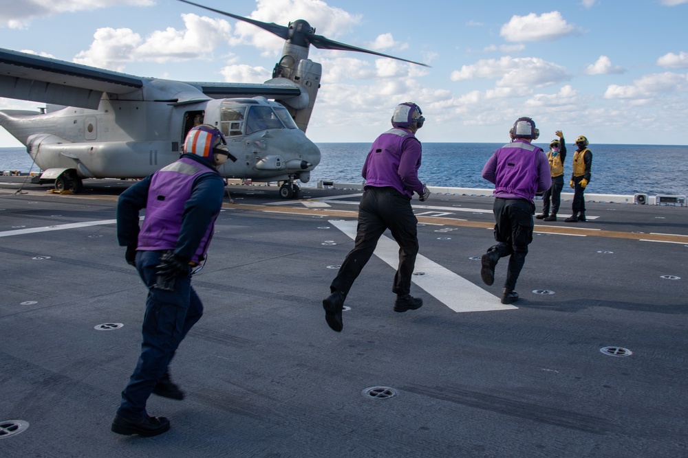 Sailors assigned to the forward-deployed amphibious assault ship USS America (LHA 6) conduct flight operations.