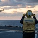 Sailor conducts flight deck operations