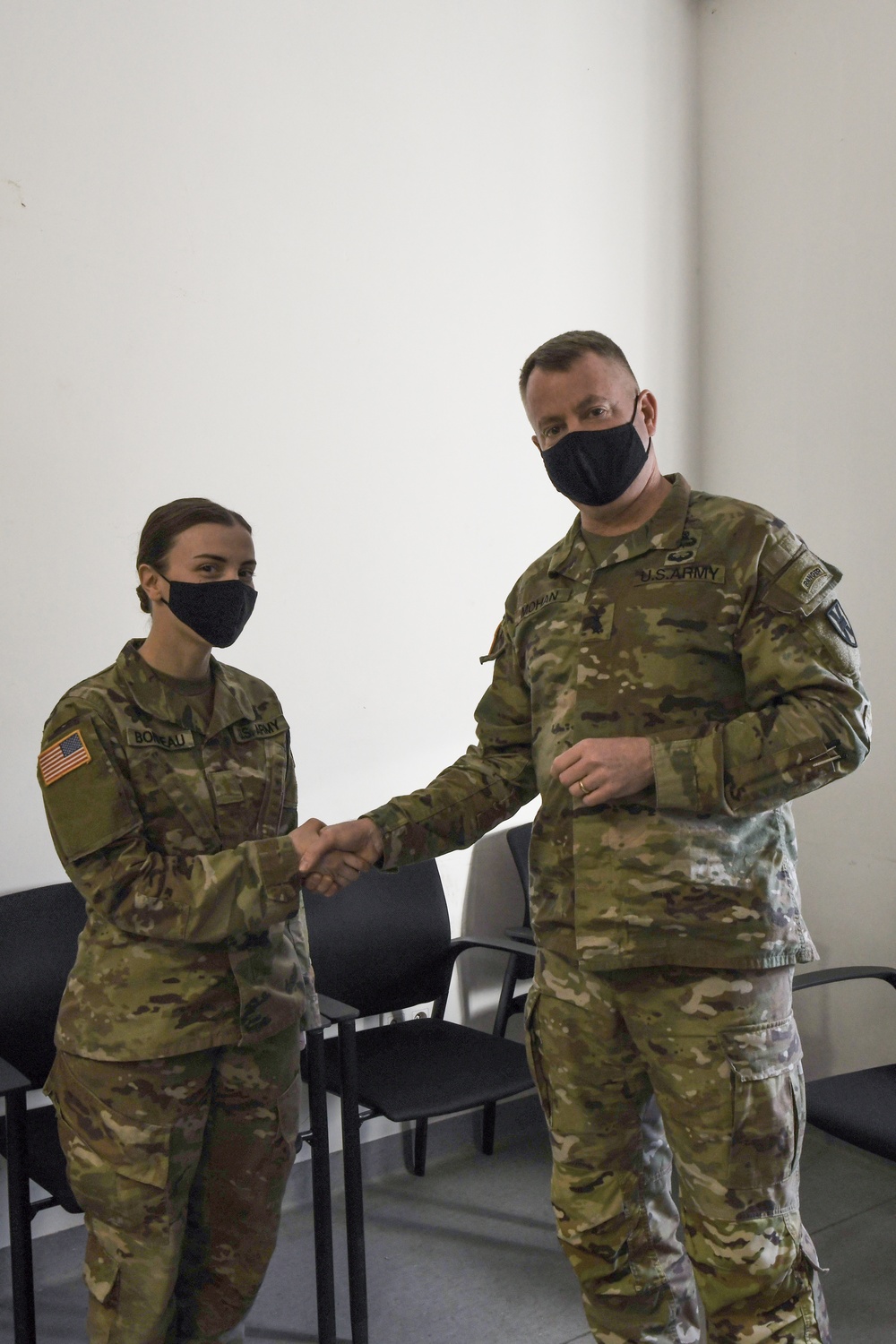 U.S. Army Maj. General Christopher Mohann presents his coin to U.S. Army 2nd Lieutenant Courtney Bonneau who currently works as the 1225th Combat Sustainment Support Battalion.