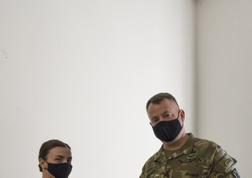 U.S. Army Maj. General Christopher Mohann presents his coin to U.S. Army 2nd Lieutenant Courtney Bonneau who currently works as the 1225th Combat Sustainment Support Battalion.