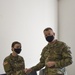 U.S. Army Maj. General Christopher Mohann presents his coin to U.S. Army 2nd Lieutenant Courtney Bonneau who currently works as the 1225th Combat Sustainment Support Battalion.