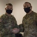 U.S. Army Maj. General Christopher Mohann presents his coin to U.S. Army Specialist Brandon Perry for performing above his grade performing as the Motor Sergeant for the 1225th Combat Sustainment Support Battalion