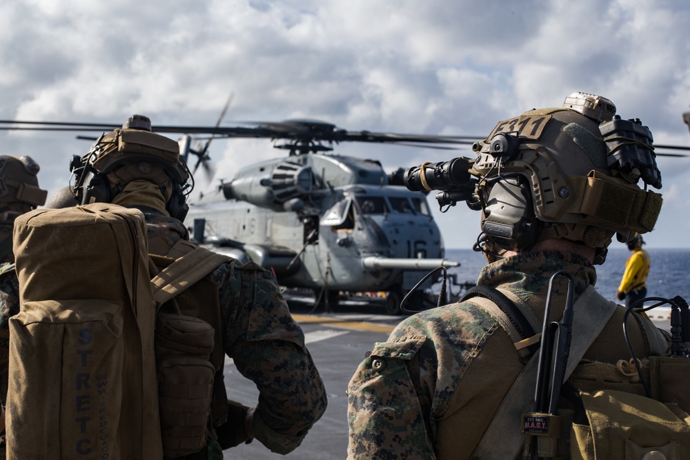 Marines aboard USS America load onto a CH-53