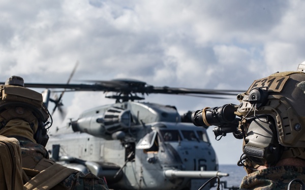 Marines aboard USS America load onto a CH-53