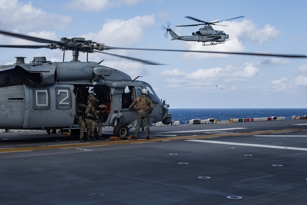 Marines aboard USS America load onto a CH-53