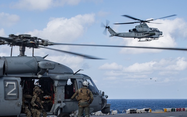 Marines aboard USS America load onto a CH-53