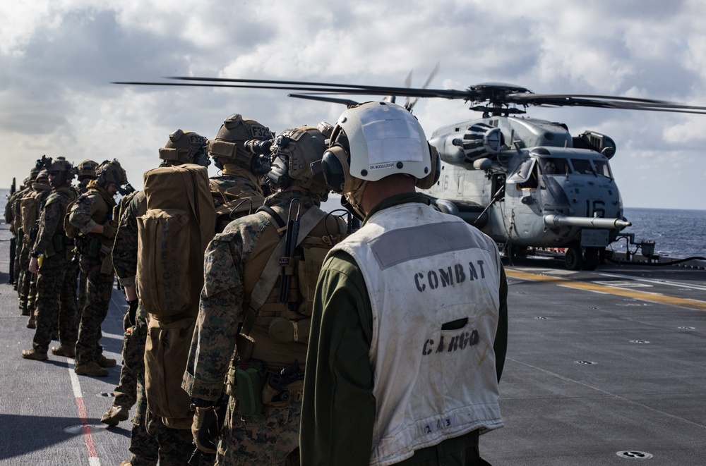 Marines aboard USS America load onto a CH-53