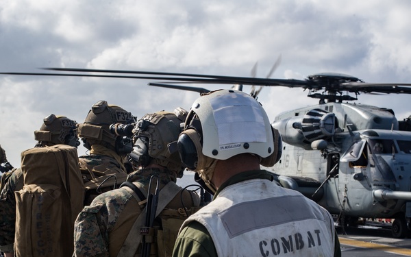 Marines aboard USS America load onto a CH-53