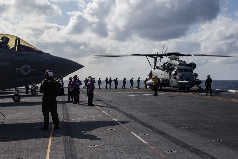 Marines aboard USS America load onto a CH-53