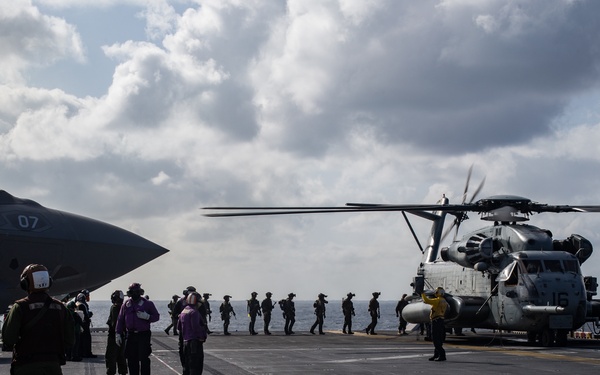 Marines aboard USS America load onto a CH-53