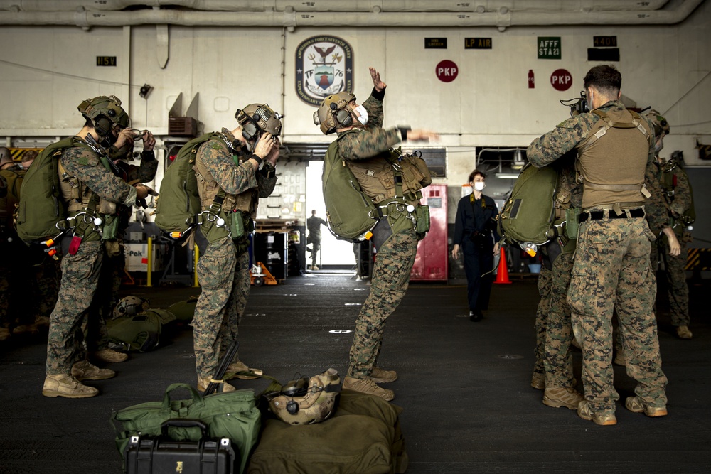 Riggers and Recon Marines jump over Ie Shima