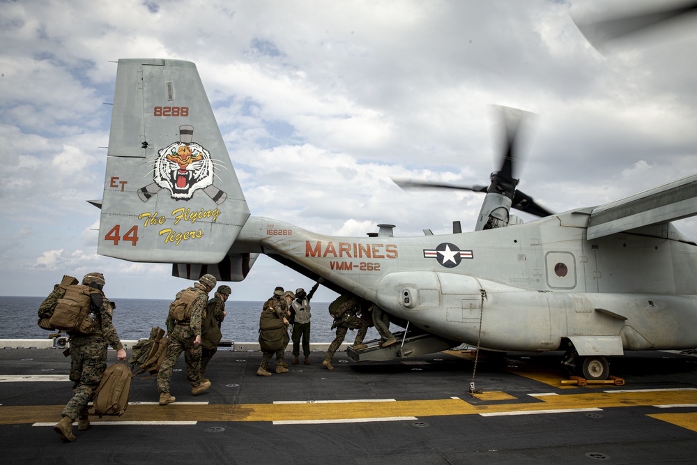 Riggers and Recon Marines jump over Ie Shima